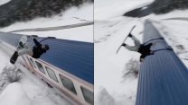 Sosyal medya çılgınlığı sınır tanımıyor: Snowboardla trenin üzerinden atladı!